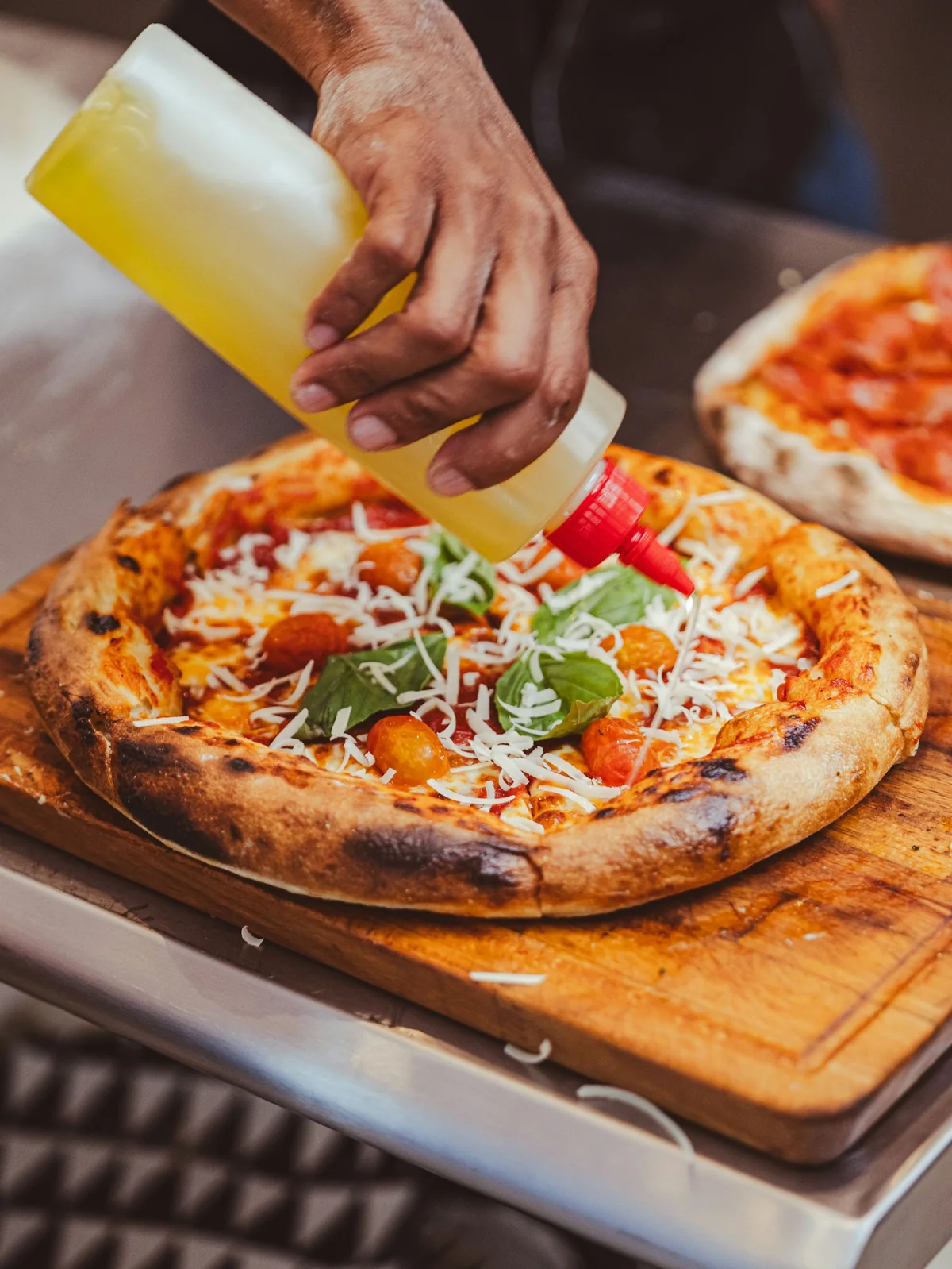 Sauce being drizzled on a pizza