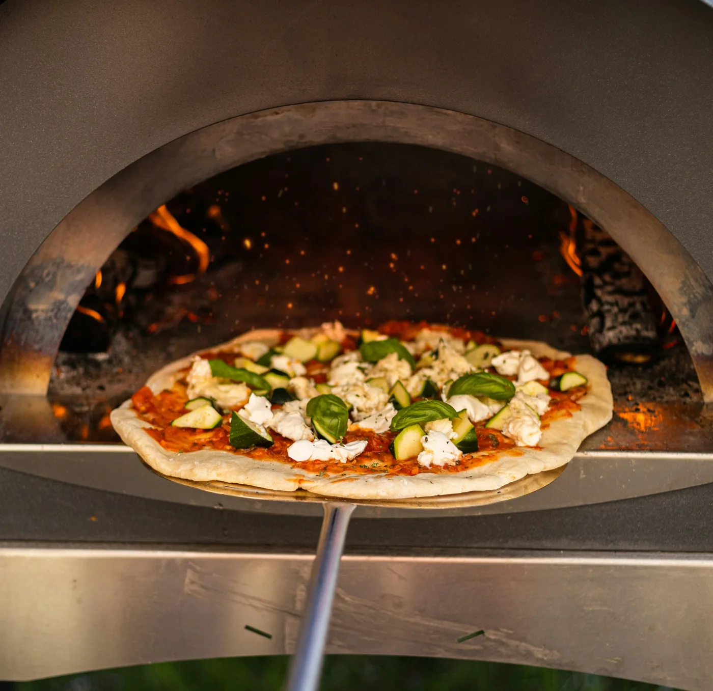 A Margherita coming out of the wood-fired oven